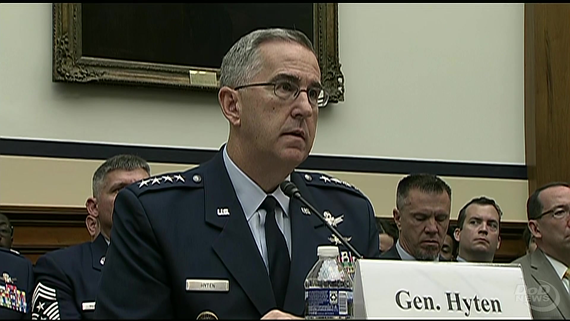 Air Force Gen. John E. Hyten, commander of U.S. Strategic Command, testifies at a table while appearing before a House panel.