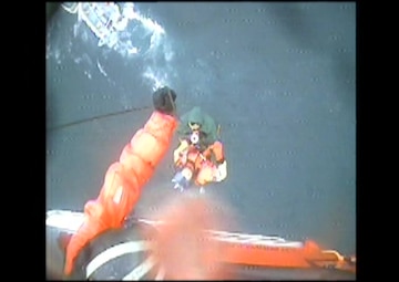 A Coast Guard Air Station Kodiak MH-65 rescue helicopter crew hoists the master of the capsized fishing vessel Miss Destinee from the good Samaritan vessel El Caparone in Marmot Bay, Alaska, June 29, 2017. Two other people were aboard the Miss Destinee and remain missing after the vessel capsized. Video by Air Station Kodiak. 