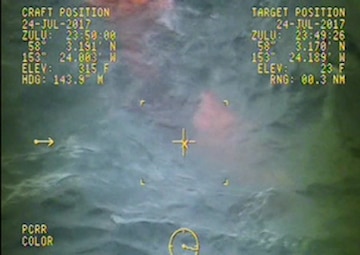 In this video provided by a Coast Guard Air Station Kodiak MH-60 Jayhawk crew, the captain of the fishing vessel Grayling jumps into the water to rescue two of his crewmen after the Grayling capsized in the Kupreanof Strait near Raspberry Island, Alaska, July 24, 2017. A good Samaritan vessel crew rescued one other crewman from the capsized Grayling. Video by Air