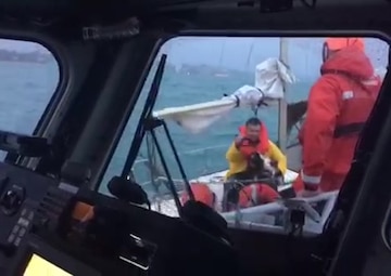 A Coast Guard Station Response Boat-medium crew transfers a dog aboard from a sailboat beset by heavy weather near Wilmette, Illinois, Oct. 22, 2017. The 37-foot sailboat was de-masted and unable to make headway back to harbor in the strong winds. U.S. Coast Guard video.