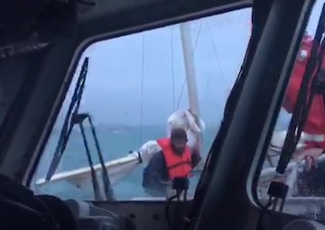 A Coast Guard Calumet Harbor Response Boat-medium crew transfers a mariner aboard from a sailboat beset by heavy weather near Wilmette, Illinois, Oct. 22, 2017. The 37-foot de-masted sailboat was left at anchor with navigation lights energized approximately one nautical mile offshore. U.S. Coast Guard video.
