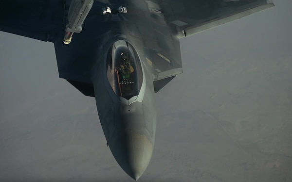 F-22 Raptors fly in formation and refuel