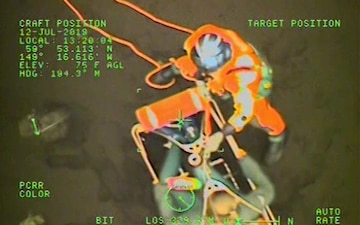 An MH-60 Jayhawk helicopter crew, from Coast Guard Air Station Kodiak and forward deployed to Cordova, hoists three people who were stranded on a beach near Cape Resurrection, Alaska, July 12, 2019.  The three people had been aboard a 19-foot skiff that overturned and were all transported to waiting emergency medical service personnel at the Seward Airport.  U.S. Coast Guard video courtesy of Air Station Kodiak.