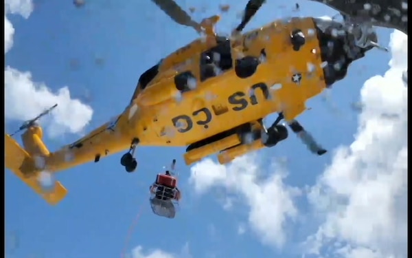 Coast Guard crewmembers from Coast Guard Station Wrightsville Beach transfer a patient to a Coast Guard MH-60 Jayhawk from Coast Guard Air Station Elizabeth City 46 miles off the coast of North Carolina during a search and rescue case August 7, 2019. One of the two passengers transferred was reportedly suffering from abdominal pain aboard a Uruguayan naval training vessel. (U.S. Coast Guard video courtesy of Petty Officer 1st Class Mark Ward)