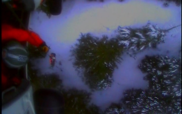An MH-60 Jayhawk helicopter crew from Air Station Sitka, Alaska, hoists an injured man who was mauled by a bear while backcountry skiing near Haines, Alaska, Saturday, February 6, 2021. The man was flown to Juneau and placed in the care of awaiting EMS. (U.S. Coast Guard video courtesy of Air Station Sitka)