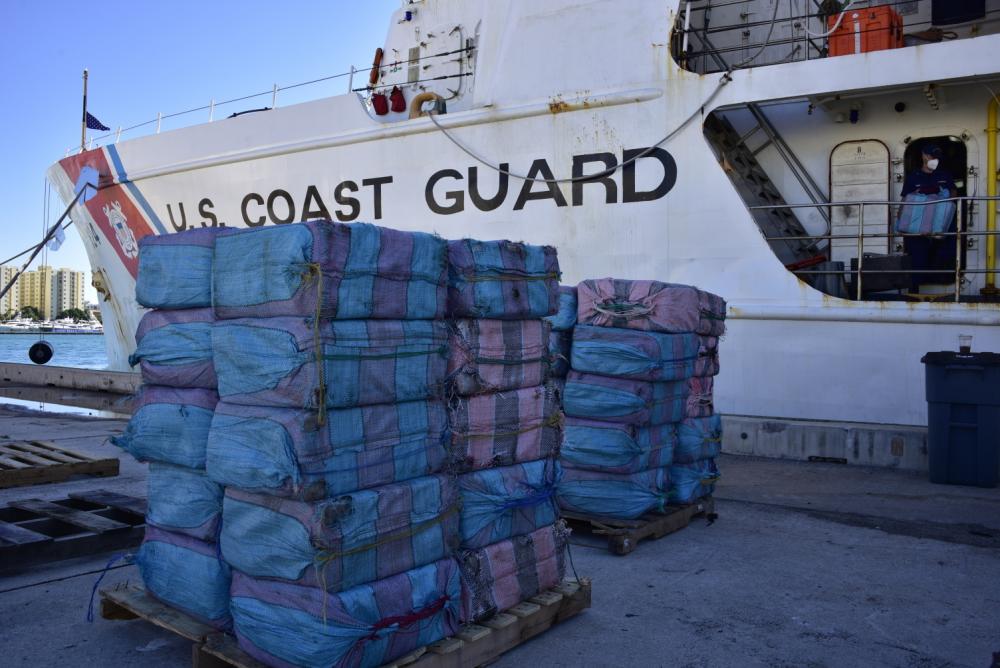 Bales of contraband are stacked in front of the Coast Guard Cutter Dauntless (WMEC-624) at Base Miami Beach, Dec. 7, 2021. The contraband was part of more than $148 million of illegal narcotics offloaded by the Dauntless crew. (U.S. Coast Guard photo by Petty Officer 3rd Class Brian Zimmerman)