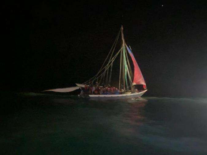 An overloaded 60-foot Haitian sailing vessel aaproximatrely 25 miles northeast of Anguilla Cay, Bahamas, Jan. 9, 2021. The wooden sailing vessel was severely overloaded and operating without basic lifesaving equipment or navigation lights. (U.S. Coast Guard photo.)