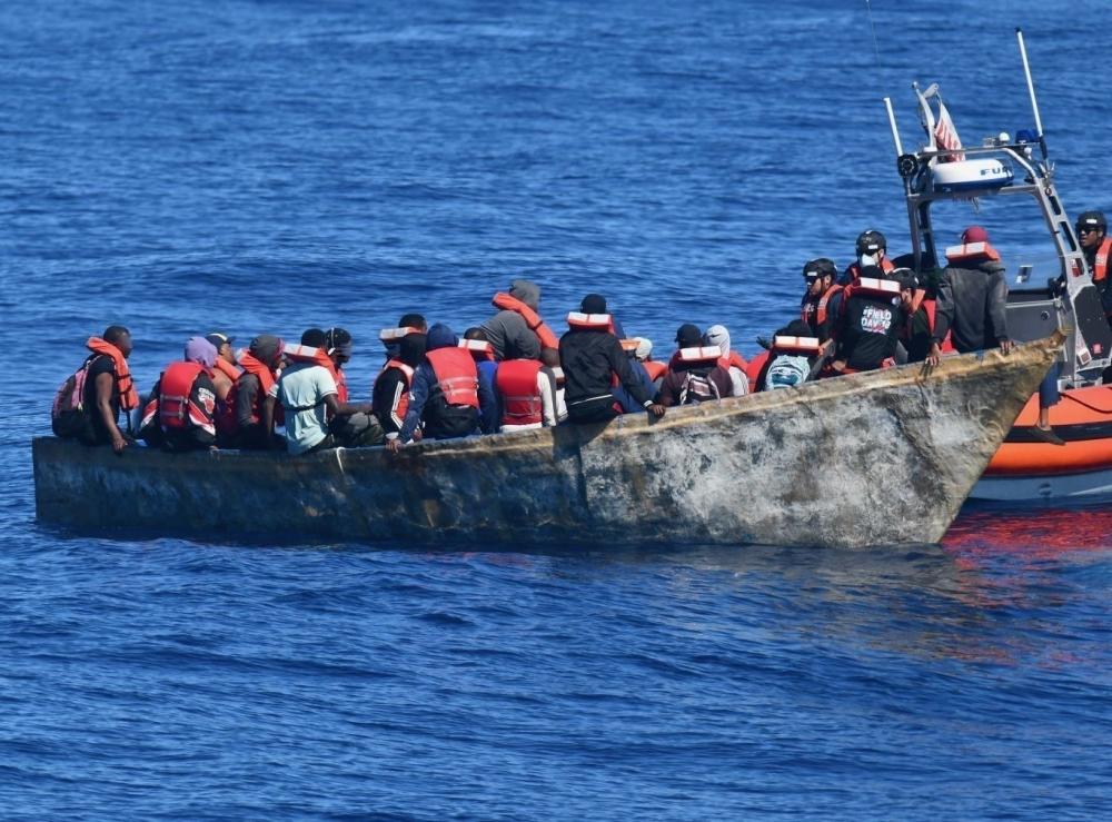 The crew of the Coast Guard Cutter Winslow Griesser interdicts a makeshift vessel part of illegal voyage Jan. 13, 2022 north of Aguadilla, Puerto Rico. Following three separate illegal voyage interdictions near Puerto Rico, the Coast Guard repatriated 90 Dominican Republic nationals, including the people in this photo, to the Dominican Republic Jan. 16, 2022. The interdictions are the result of ongoing local and federal multi-agency efforts in support of the Caribbean Border Interagency Group CBIG. (U.S. Coast Guard photo)