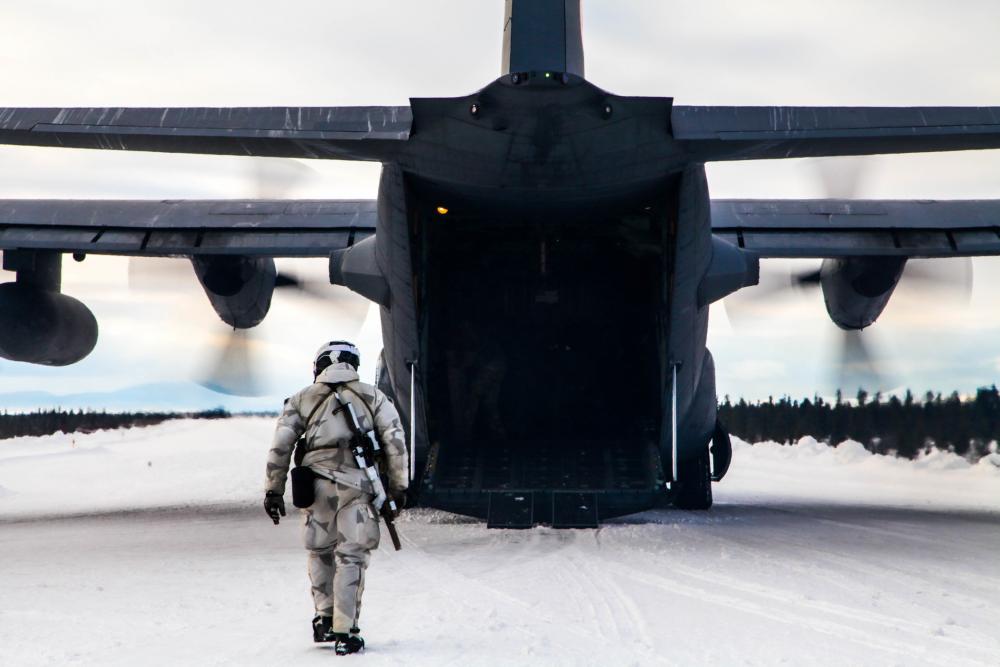 U.S. Army Special Forces assigned to 10th Special Forces Group (Airborne) load equipment onto a U.S. Air Force C-130 Hercules