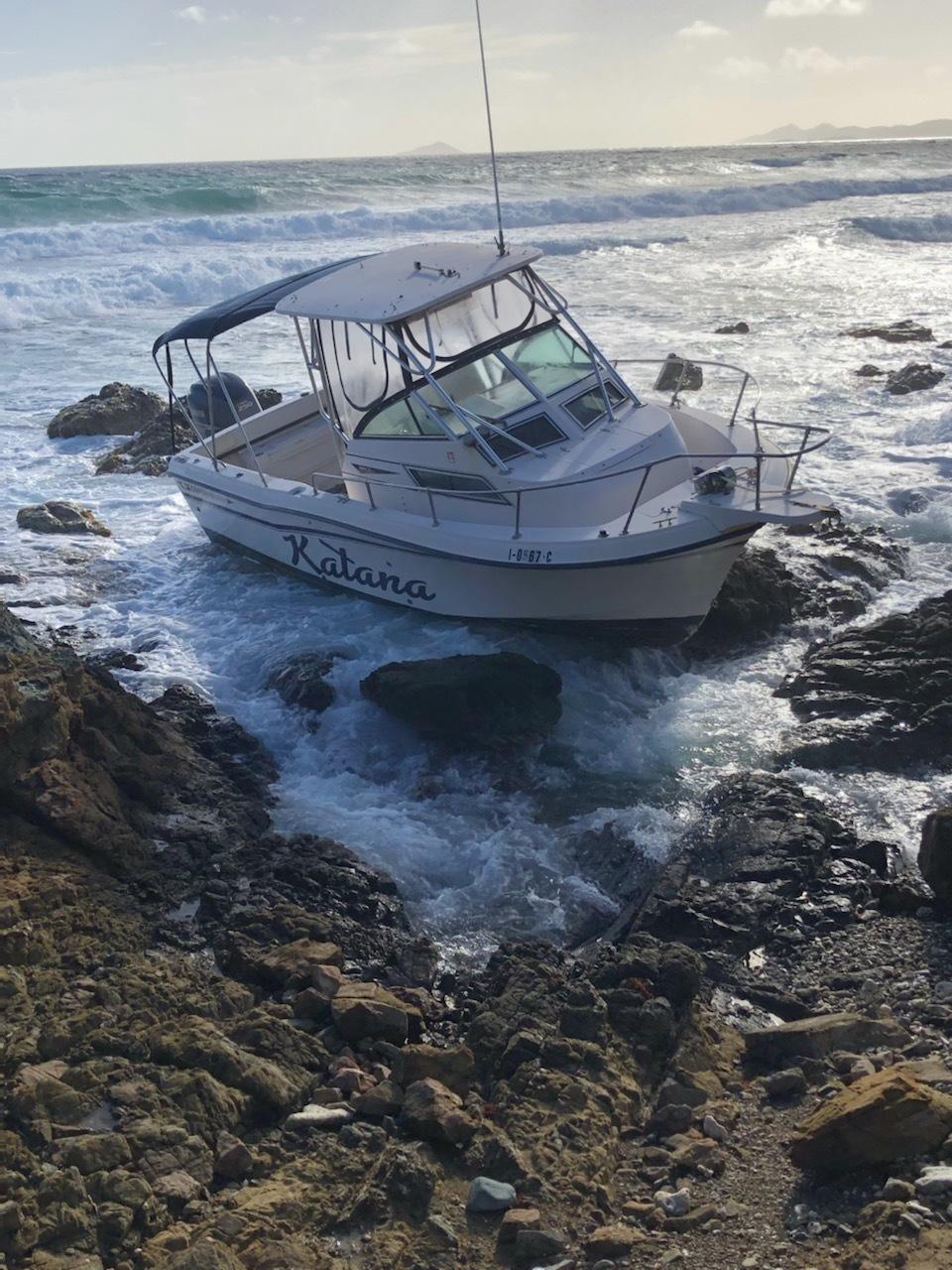 The pleasure craft Katana washed ashore on the rocks the morning of March 7, 2022, near Judith’s Fancy in St. Croix, U.S. Virgin Islands, after a Coast Guard boat crew rescued four men and five women from the vessel the evening of March 6, 2022, when the vessel reportedly ran out of fuel and started drifting towards the rocks. (U.S. Coast Guard photo)