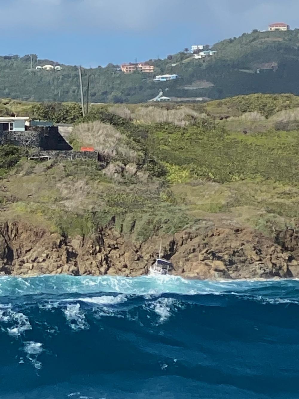 The pleasure craft Katana washed ashore on the rocks the morning of March 7, 2022, near Judith’s Fancy in St. Croix, U.S. Virgin Islands, after a Coast Guard boat crew rescued four men and five women from the vessel the evening of March 6, 2022, when the vessel reportedly ran out of fuel and started drifting towards the rocks. (U.S. Coast Guard photo)