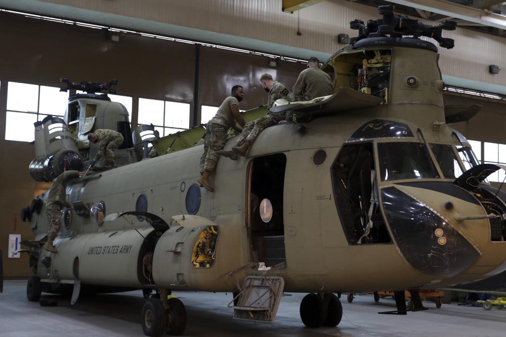Soldiers working on a Chinook F-model helicopter