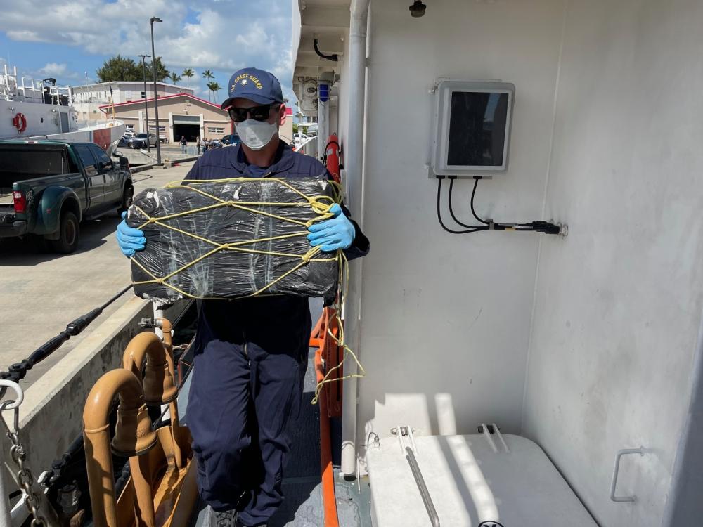 A Coast Guard Cutter Donald Horsley crewmember helps offload approximately 1,000 kilograms of seized cocaine, valued at $20 million dollars, at Coast Guard Base San Juan April 4, 2022, following the interdiction of a go-fast vessel March 30, 2022 in the Caribbean Sea near Puerto Rico. Drug Enforcement Administration Special Agents received custody of two suspected smugglers and the seized contraband. This interdiction is the result of multi-agency efforts involving the Caribbean Border Interagency Group and the Caribbean Corridor Strike Force. (U.S. Coast Guard photo)
