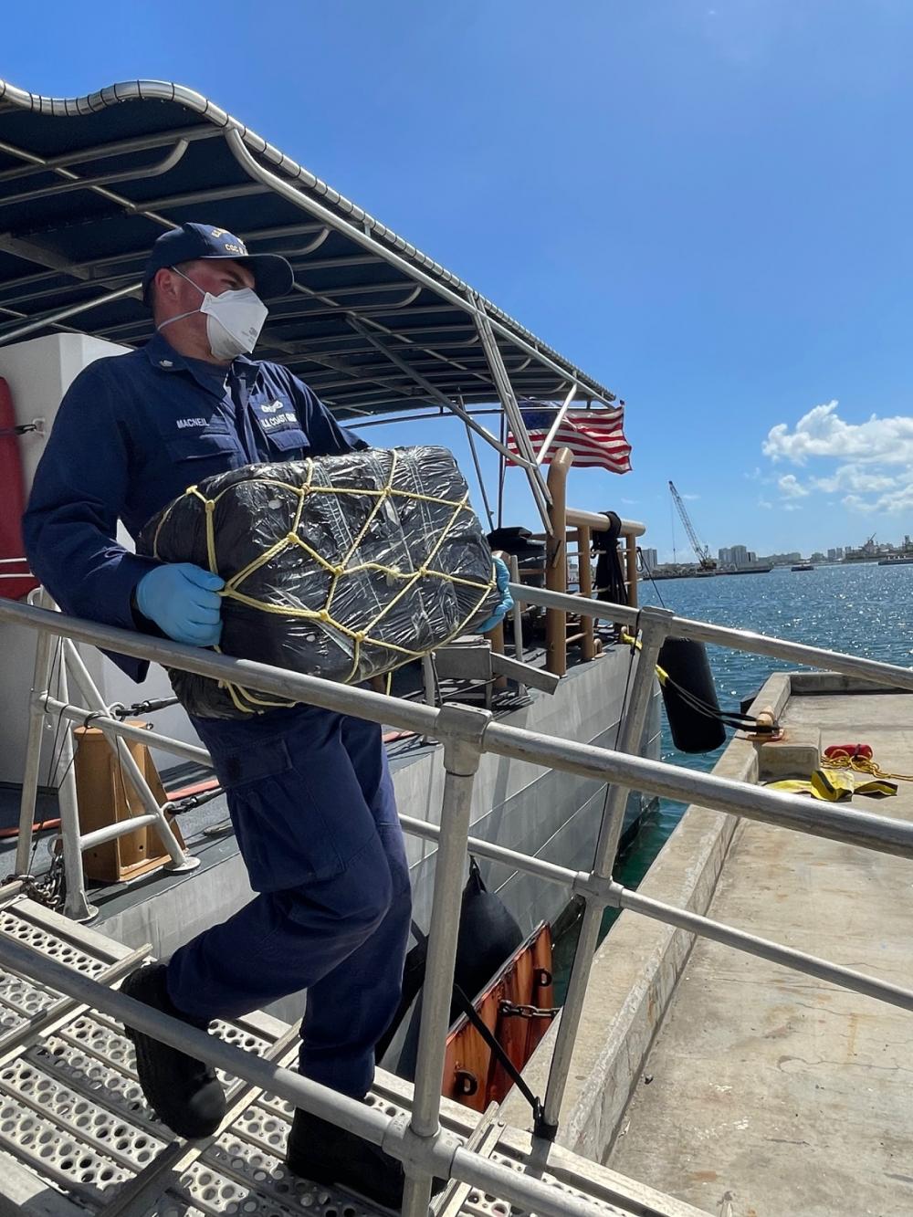 A Coast Guard Cutter Donald Horsley crewmember helps offload approximately 1,000 kilograms of seized cocaine, valued at $20 million dollars, at Coast Guard Base San Juan April 4, 2022, following the interdiction of a go-fast vessel in the Caribbean Sea March 30, 2022 near Puerto Rico. Drug Enforcement Administration Special Agents received custody of two suspected smugglers and the seized contraband. This interdiction is the result of multi-agency efforts involving the Caribbean Border Interagency Group and the Caribbean Corridor Strike Force. (U.S. Coast Guard photo)