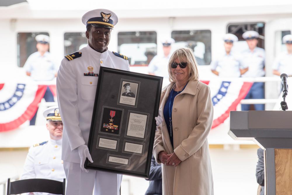 Lt. David Anderson, commanding officer of USCGC Clarence Sutphin Jr. (WPC 1147), and. Mona Sutphin Roserro, the ship's sponsor and daughter of the cutter's namesake is Boatswain's Mate 1st Class Clarence Sutphin Jr. honors his service at the ship's commissioning ceremony in New York City, on April 21, 2022. 