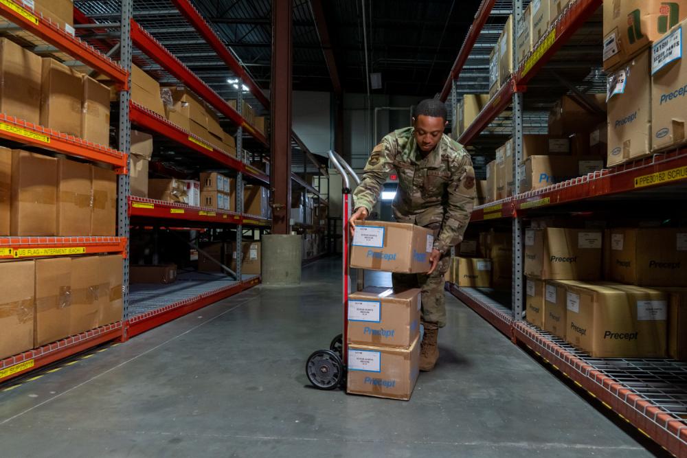 Air Force Mortuary Affairs Operations departures specialist assists with receiving logistical supplies