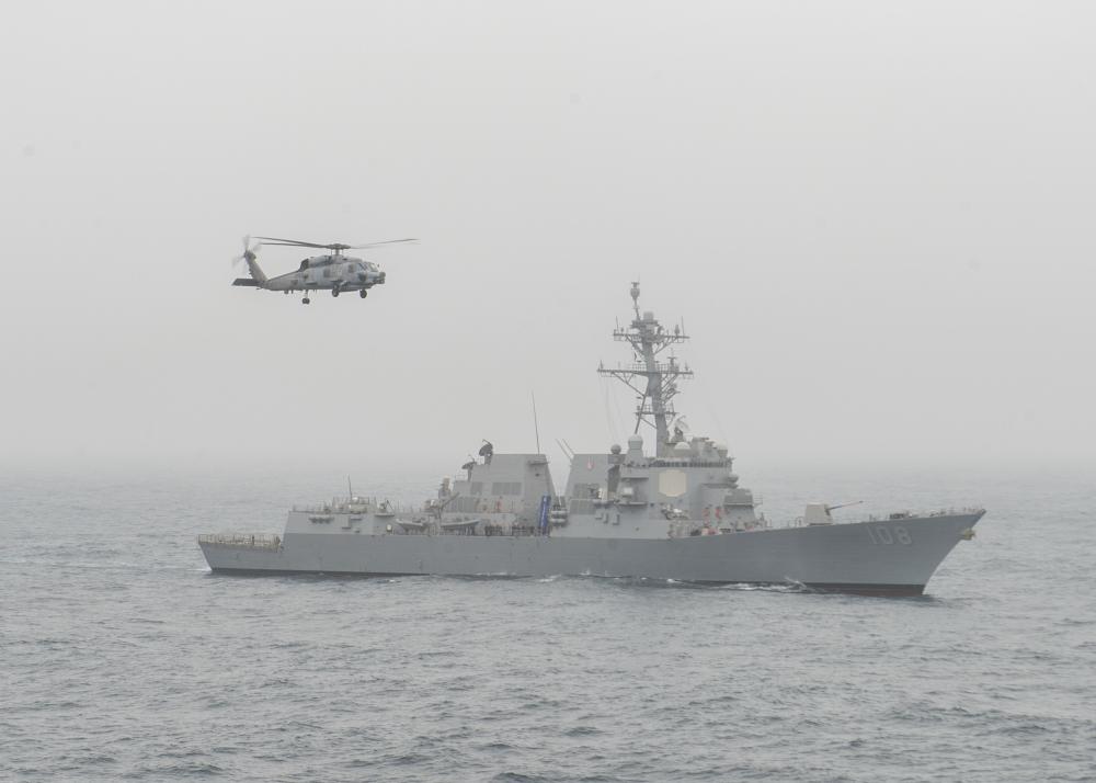 An MH-60R and USS Wayne E. Meyer Sail With USS Nimitz
