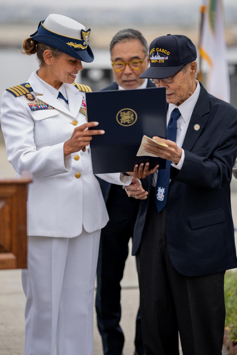 Captain Rebecca Ore, commanding officer Sector Los Angeles-Long Beach presents Rikio Izumi, Coast Guard veteran with the National Defense Service Medal for his service during the Korean War, San Pedro, California, June 10, 2022. Mr. Izumi, born in Hawaii in 1930 served in the Coast Guard from 1951 to 1953. (U.S. Coast Guard photo by Petty Officer 3rd Class Aidan Cooney)
