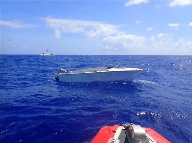 The Coast Guard Cutter Joseph Tezanos is on-scene with a makeshift vessel interdicted July 8, 2022 in Mona Passage waters near Puerto Rico. Thirty-six Dominicans who were taking part in an illegal voyage were safely removed from the vessel and repatriated to the Dominican Republic. (U.S. Coast Guard photo)