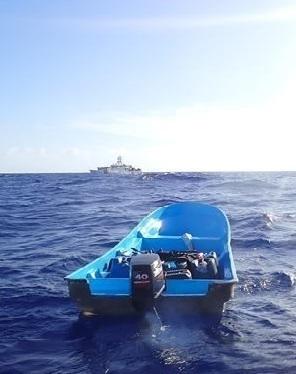 The Coast Guard Cutter Joseph Tezanos is on-scene with a makeshift vessel interdicted July 28, 2022 in international waters north of Punta Cana, Dominican Republic. Nineteen Dominicans, 18 men and a woman, who were taking part in this illegal voyage were repatriated to a Dominican Republic Navy vessel July 29, 2022 along with 17 other Dominicans from a separate interdiction. (U.S. Coast Guard photo)