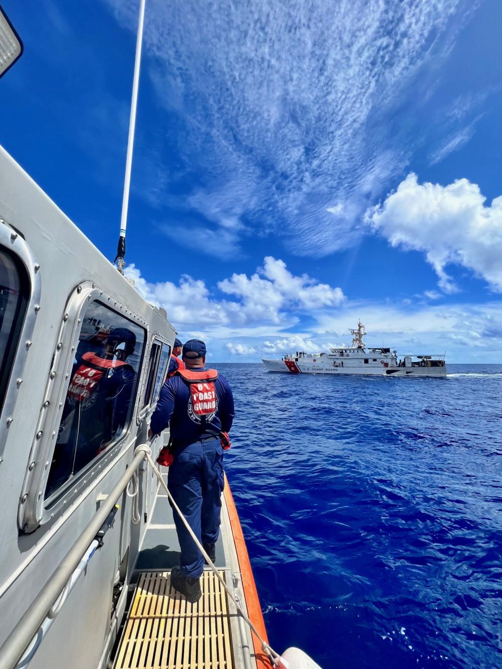 Members of a U.S. Coast Guard Station Apra Harbor 45-foot Response Boat Medium approach the USCGC Frederick Hatch (WPC 1143)