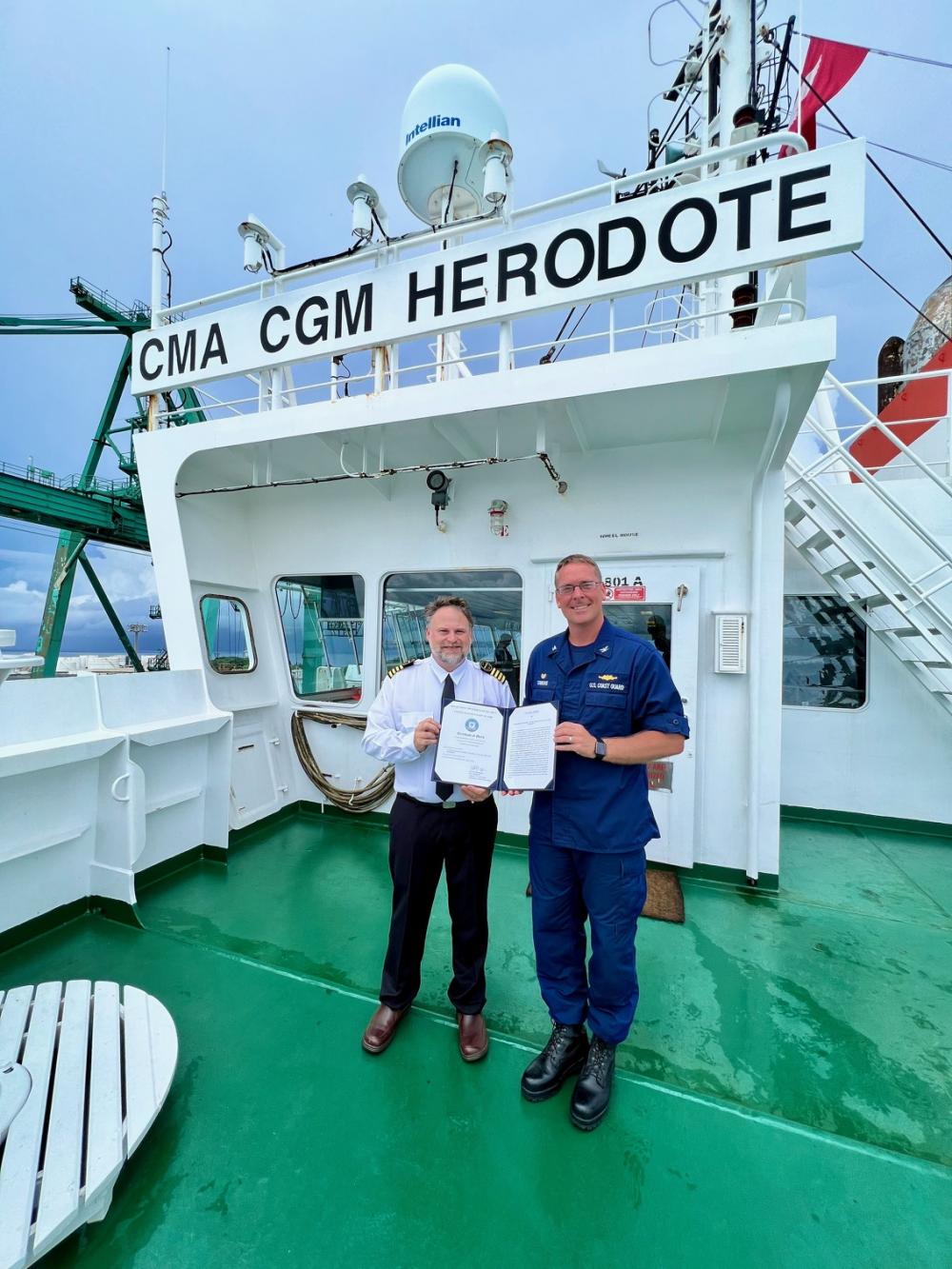 Capt. Nick Simmons, U.S. Coast Guard Forces Micronesia/Sector Guam commander, presented Capt. Donald Moore and the crew a Coast Guard Certificate of Merit for their efforts to rescue fishers more than 100 miles off Japan after their vessel suffered a fire on March 21. 