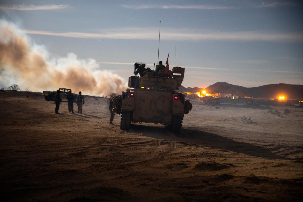 A Bradley Fighting Vehicle prepares to breech the defenses of a checkpoint during a training exercise