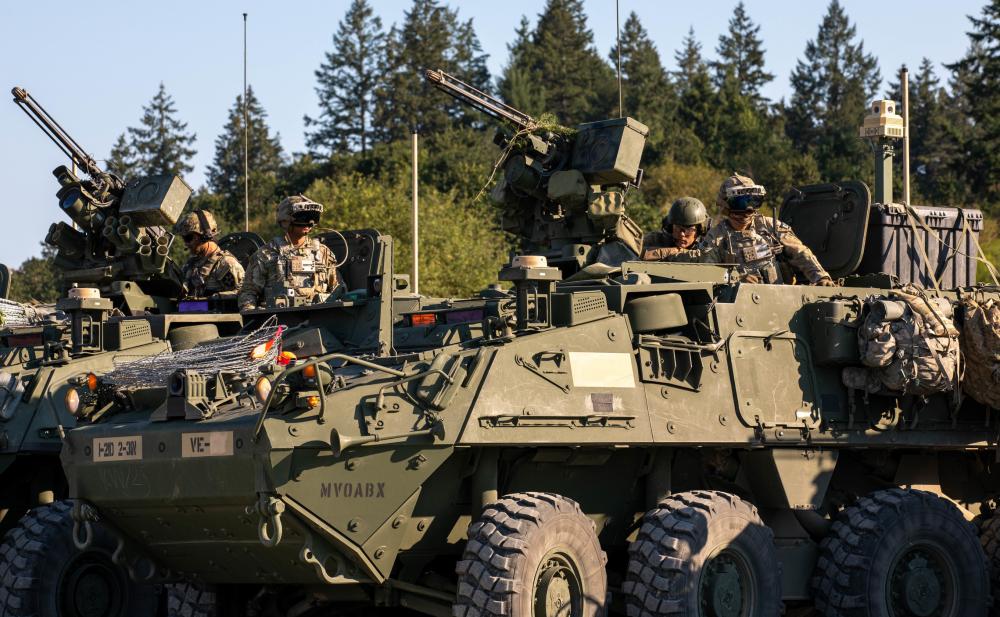 Soldiers from 1-2 Stryker Brigade Combat Team wear upgraded Integrated Visual Augmentation System goggles while sitting atop Stryker armored vehicles