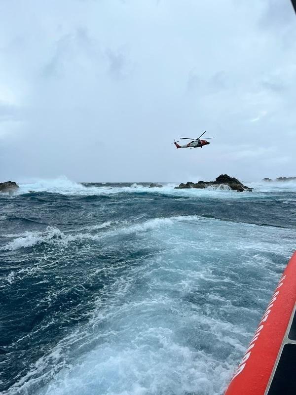 A Coast Guard 33-foot Special Purpose Craft and a Coast Guard MH-60T Jayhawk helicopter on scene during the rescue of a spear fisherman from the rocks just off Dog Island southeast of St. Thomas, U.S. Virgin Islands Sept. 4, 2022. The survivor, reportedly over 50-years-old, was safely transferred to the Cyril E. King airport in St. Thomas, U.S. Virgin Islands, where he was received by awaiting Emergency Medical Service personnel. (U.S. Coast Guard video)