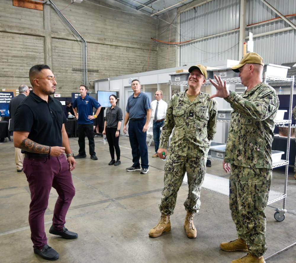 Capt. Cory Schemm and Rear. Adm. Bradley Rosen discuss the new warehouse technologies during a tour of NAVSUP’s 5G smart warehouse located on Naval Air Station North Island 8 Sept 2022.