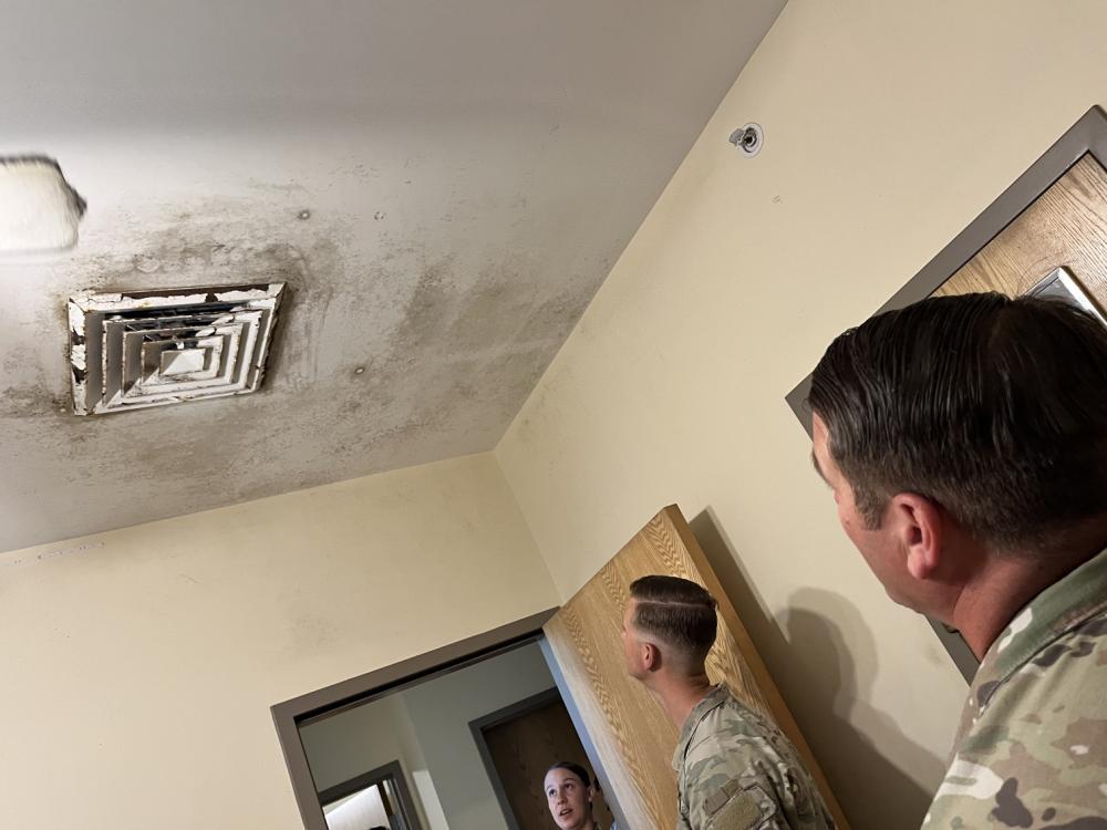 Soldiers looking at ceiling mold