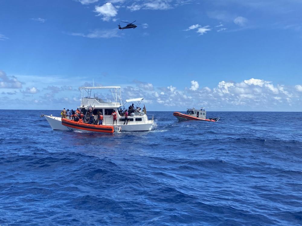 Coast Guard law enforcement crews rescue people from an unsafe and overloaded 40-foot cabin cruiser about 20 miles off Boca Raton, Florida, Oct. 12, 2022. The people were transferred to Bahamian authorities, Oct 16, 2022. (U.S. Coast Guard photo by Station Lake Worth's crew)