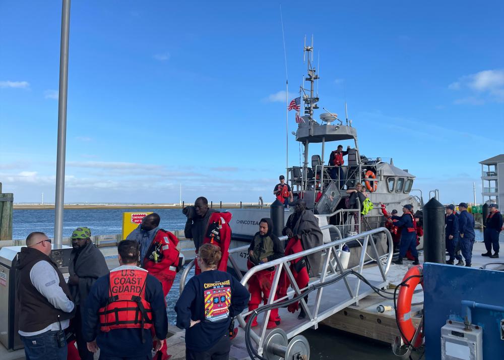 A Coast Guard Station Chincoteague 47-foot Motor Life Boat crew safely transfers 12 people ashore at the station Oct. 28, 2022 in Chincoteague, Virginia after they were rescued from the sinking 115-foot fishing vessel Tremont approximately 63 miles southeast of Chincoteague.
