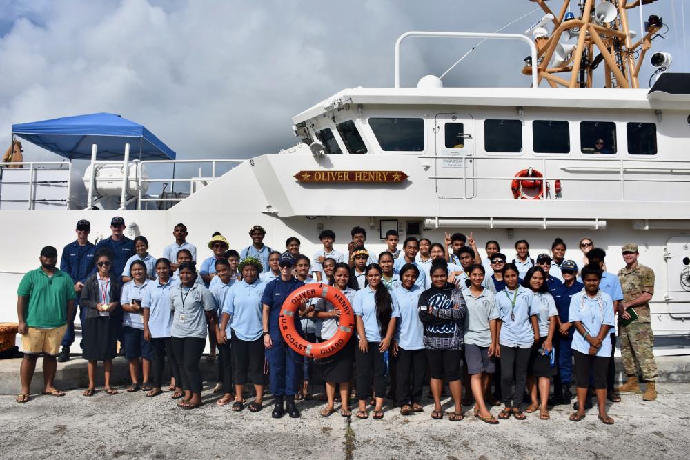 Yap Catholic High School students stand for a photo with the crew of USCGC Oliver Henry 