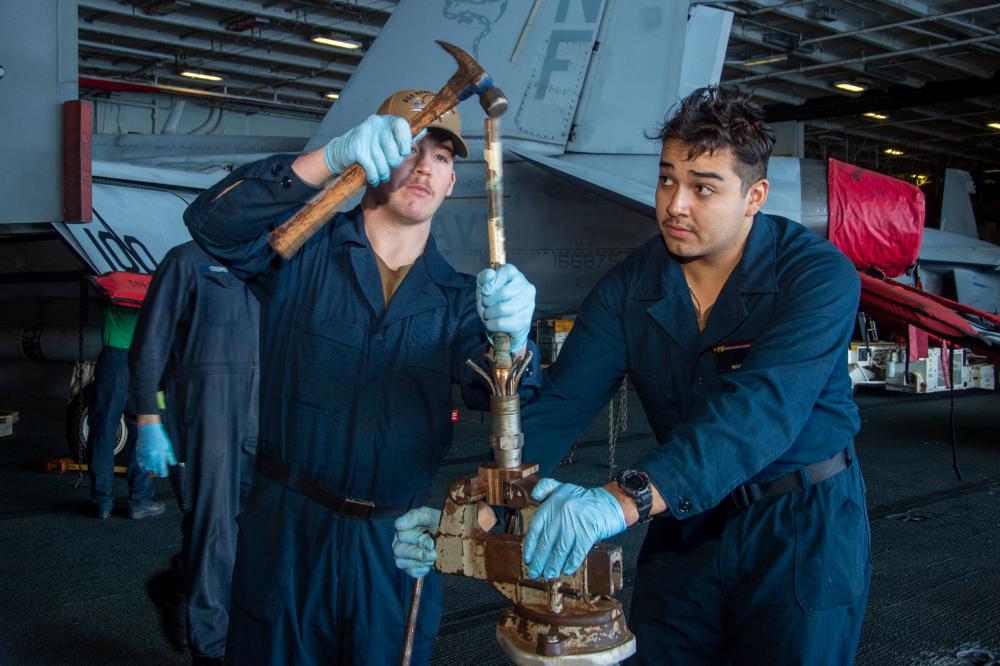 USS Ronald Reagan (CVN 76) Sailors conduct maintenance on hangar bay door
