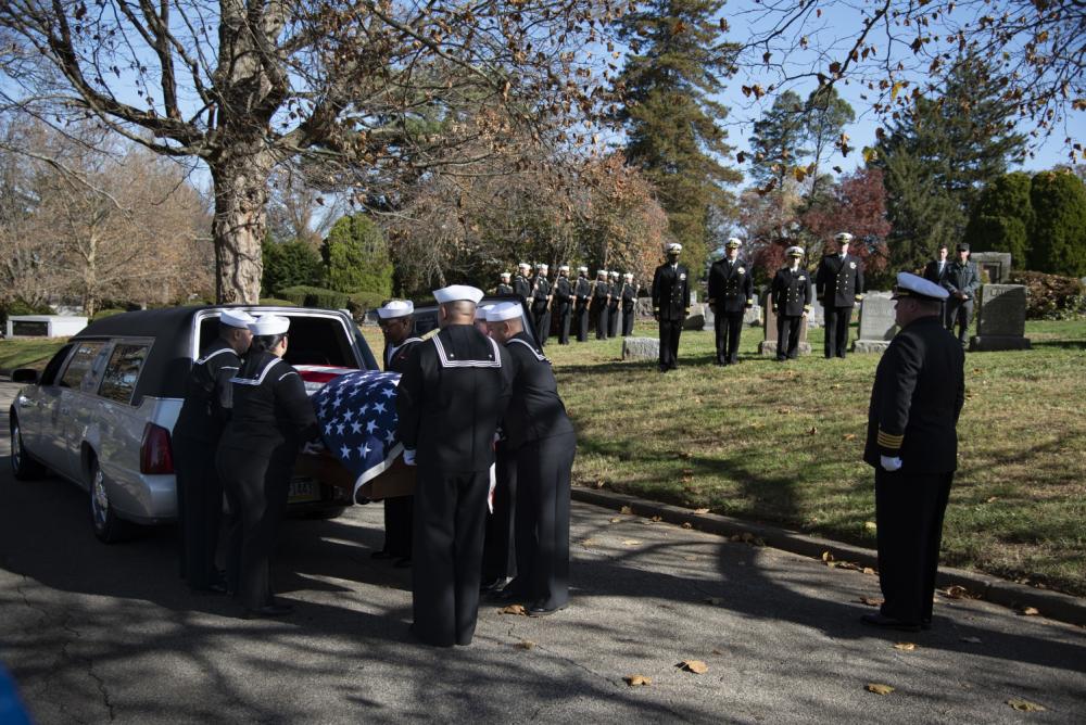 Naval Support Activity Philadelphia's Funeral Honors Detail remove the remains of Radioman 3rd Class Charles Montgomery