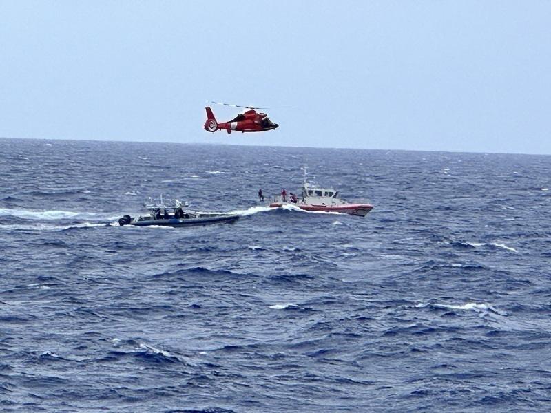 A Coast Guard Station Islamorada small boat crew, Coast Guard Air Station Miami MG-65 helicopter aircrew, and a Customs and Border Protection Air and Marine Operations small boat crew search for people in the water near Rodriguez Key, Florida, Nov. 21, 2022. The people were repatriated to Haiti on Nov. 25, 2022. (U.S. Coast Guard photo by Lt. Robert Collins)