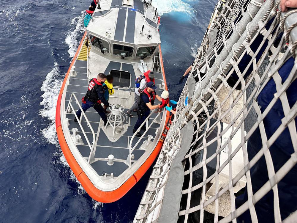 A Coast Guard Station Islamorada crew transfers people rescued from an overloaded sailing vessel to the Coast Guard Cutter Escanaba near Rodriguez Key, Florida, Nov. 21, 2022. The people were repatriated to Haiti on Nov. 25, 2022. (U.S. Coast Guard photo by Lt. Robert Collins)