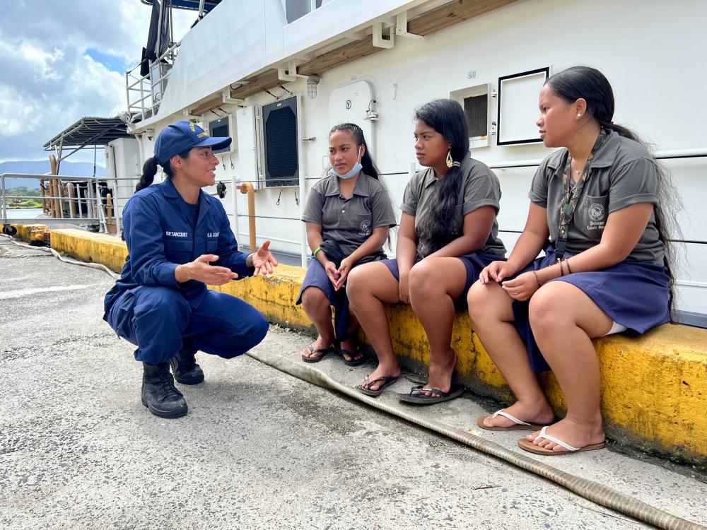 Seaman Paula Betancourt of the USCGC Frederick Hatch (WPC 1143) talks about the U.S. Coast Guard with students from Pohnpei Catholic School at the pier in Pohnpei, Federated States of Micronesia, on Nov. 22, 2022. 