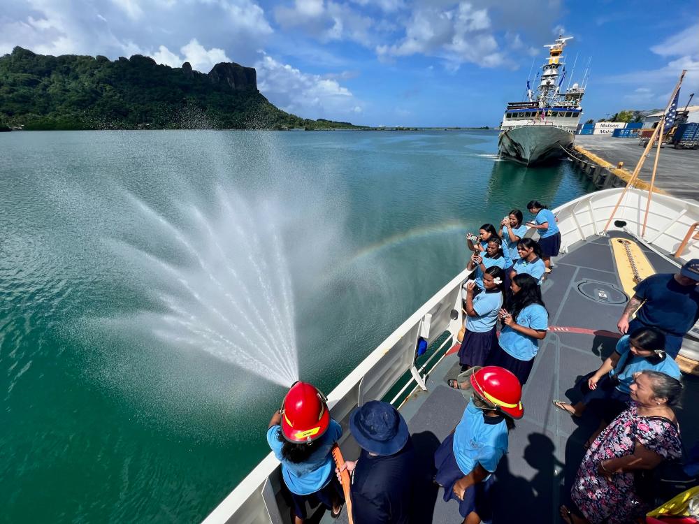 The crew of the USCGC Frederick Hatch (WPC 1143) demonstrates firefighting to students from Cavalry Christian School as the crew hosts students aboard the cutter at the pier in Pohnpei, Federated States of Micronesia, on Nov. 22, 2022.