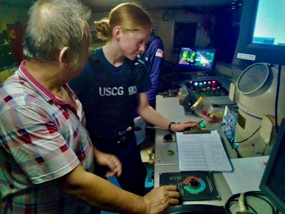 Lt. j.g. Mary Sims of USCGC Frederick Hatch (WPC 1143), reviews documents with the master of a Federated States of Micronesia-flagged fishing vessel during a fisheries boarding in the Federated States of Micronesia exclusive economic zone on Dec. 17, 2022, under the newly expanded bilateral agreement. 