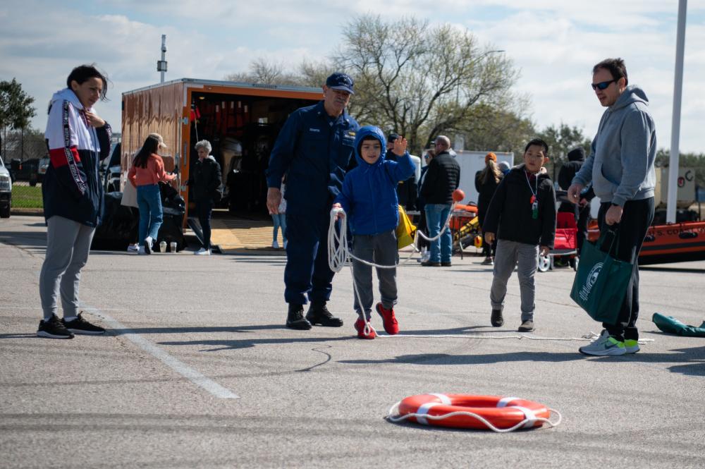 Members of the public attempt to throw a heaving line into a life ring during Sector Houston-Galveston’s Community Day in Houston, Texas, Feb. 11, 2023. During the event, Coast Guard members from Sector Houston-Galveston and surrounding units displayed equipment and discussed various Coast Guard missions. (U.S. Coast Guard photo by Petty Officer 3rd Class Alejandro Rivera)