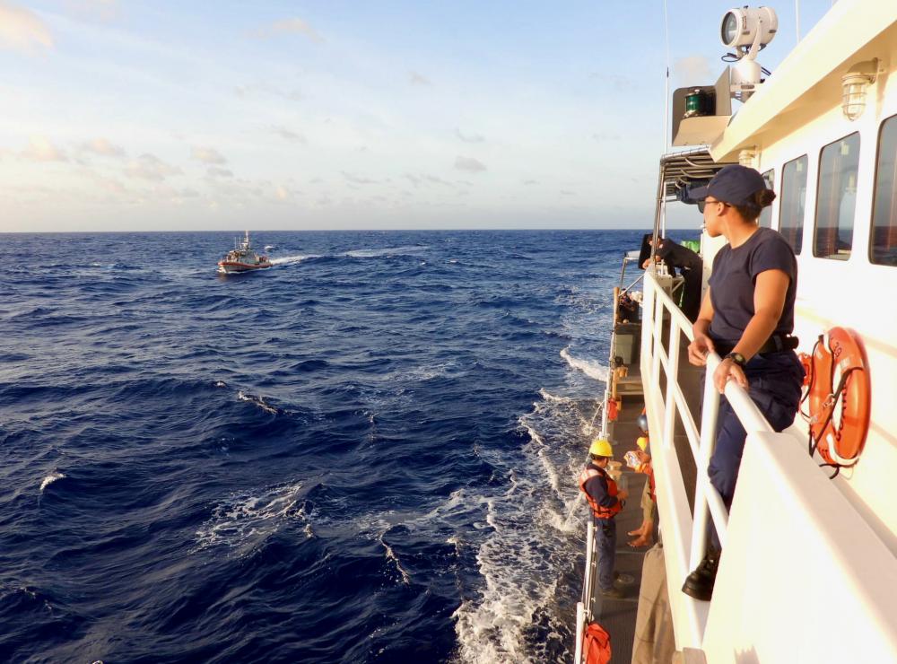 The crew of the USCGC Myrtle Hazard (WPC 1139) transfers two mariners rescued from the water about halfway between Guam and Rota midday on Feb. 9, 2023, to a Station Apra Harbor 45-foot Response Boat-Medium for further transport to shore.