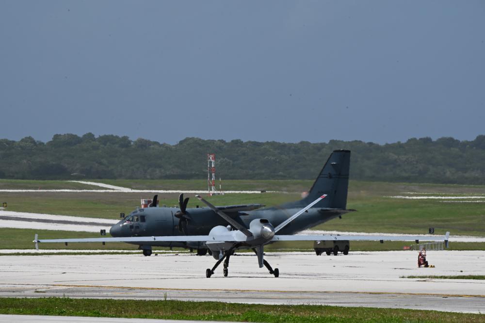 U.S. Air Force MQ-9 Reaper taxis past Royal Australian Air Force C-27 on flighline during Cope North at Andersen Air Force Base, Guam, Feb. 20 2023.