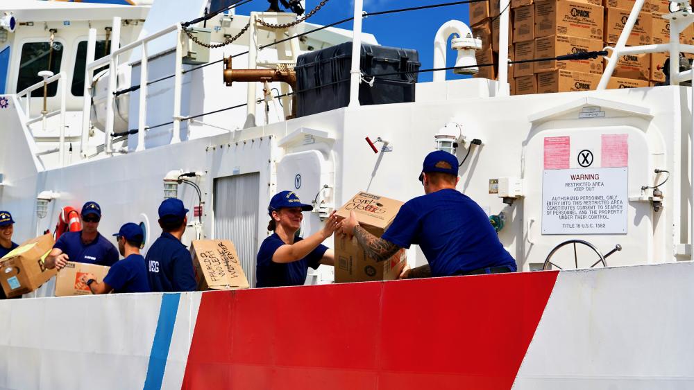 The crew of USCGC Oliver Henry (WPC 1140) loads more than 4,500 pounds of donations from the Ayuda Foundation bound for Yap State