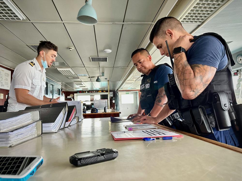 A Sector Boarding Team from U.S. Coast Guard Forces Micronesia/Sector Guam reviews documentation aboard the bridge of the 633-foot Bahamas-flagged MS Amadea following its arrival to Guam on Feb. 24, 2023.