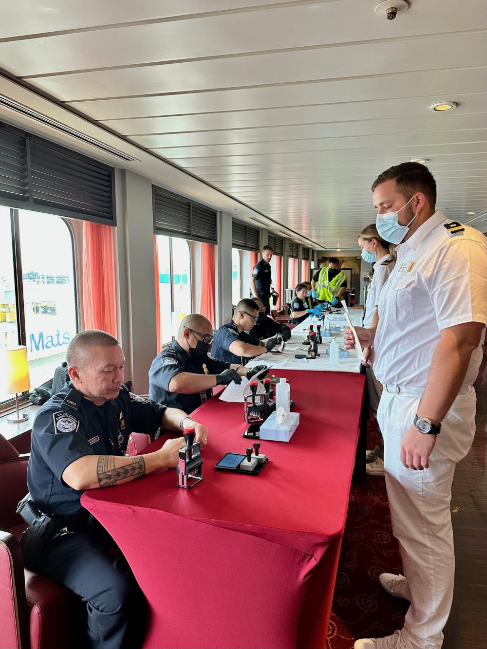 U.S. Customs and Border Protection personnel review passports and other documentation for the crew aboard the 633-foot Bahamas-flagged MS Amadea following its arrival to Guam on Feb. 24, 2023. 