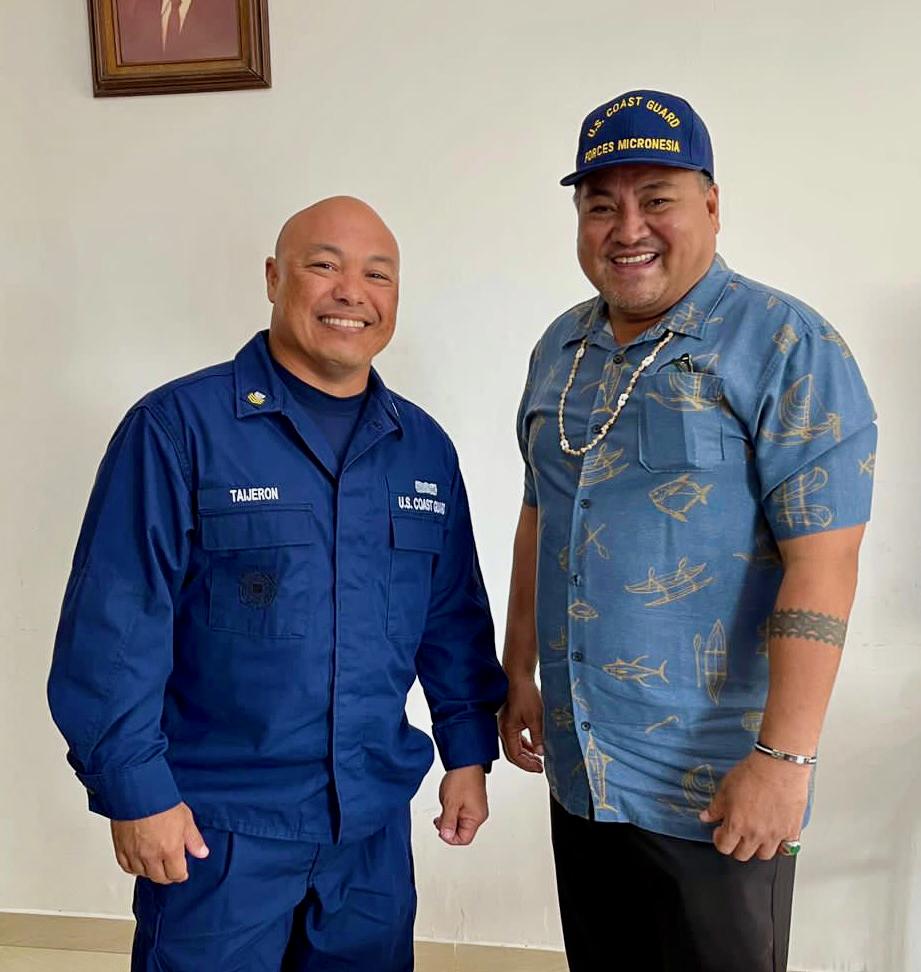 Petty Officer 1st Class Juan Taijeron, originally from the Federated States of Micronesia, currently serving at U.S. Coast Guard Station Apra Harbor, in Guam, stands for a photo with the Governor of Chuuk, the Honorable Alexander Narruhn, in Weno, Chuuk, the Federated States of Micronesia, on Feb. 22, 2023.