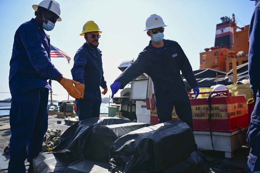 Crewmembers from Coast Guard Cutter Spencer offload interdicted narcotics in Port Everglades, Florida, March 8, 2023. The offload contained an estimated $160 million in cocaine that the Coast Guard and its partners intercepted in the international waters of the Caribbean Sea and the Atlantic Ocean. (U.S. Coast Guard photo by Petty Officer 3rd Class Eric Rodriguez.)