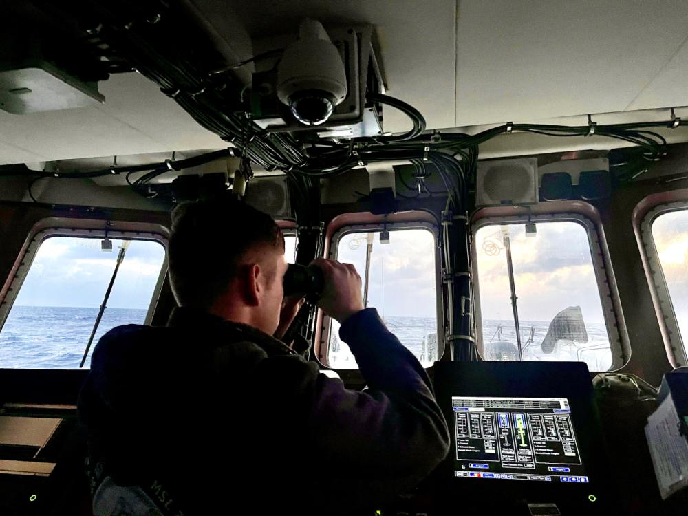 Lt. j.g. Dale Walters keeps a lookout for a missing 31-year-old spearfisher from the bridge of the USCGC Myrtle Hazard (WPC 1139) on March 17, 2023.